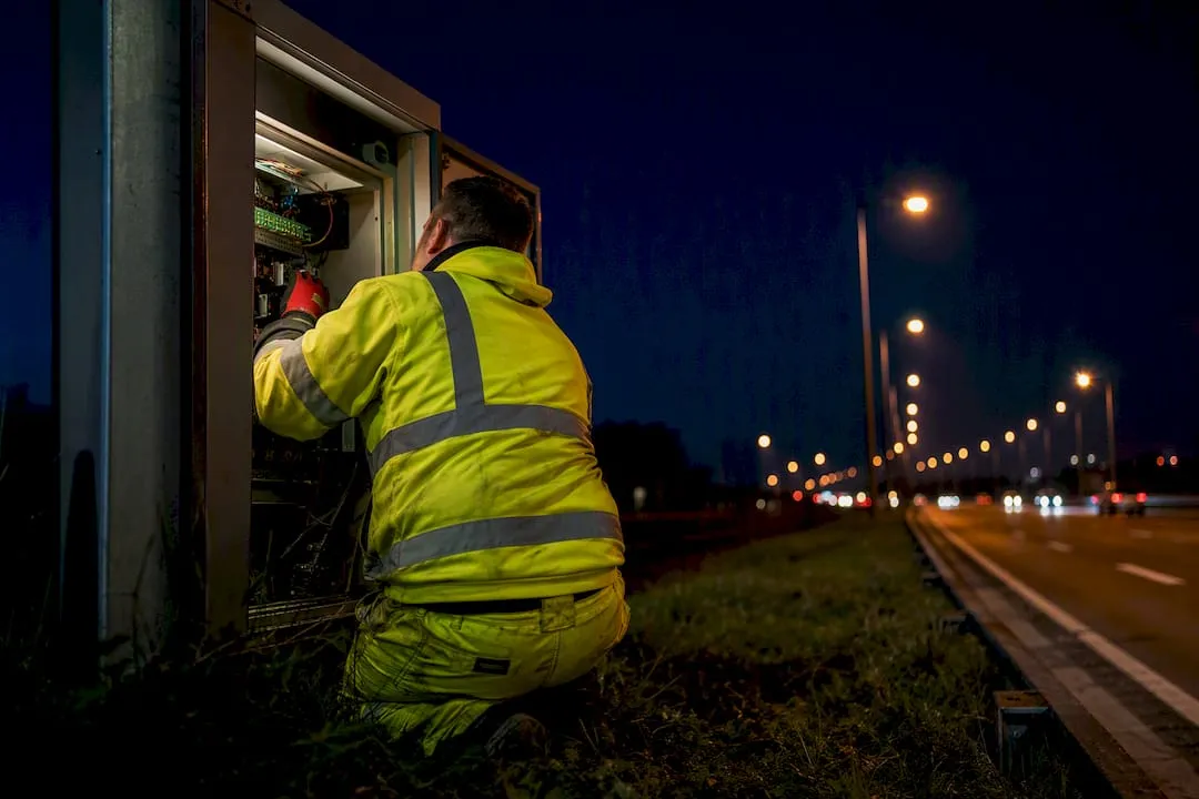 Electrician checking roadside control equipment